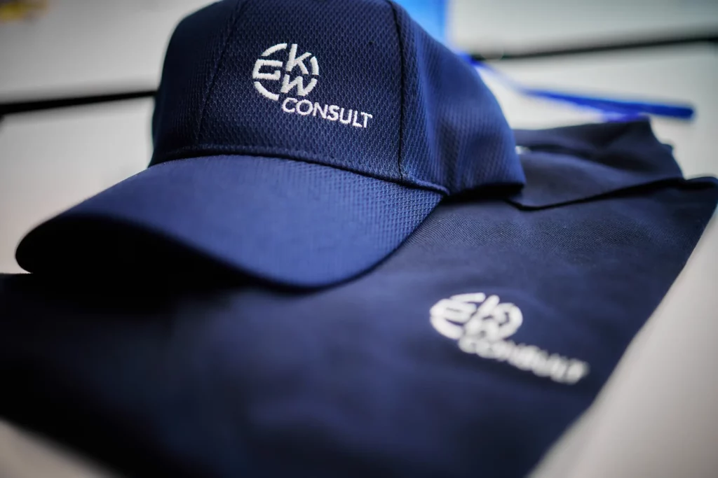 Navy GKW Consult cap resting on matching branded workwear