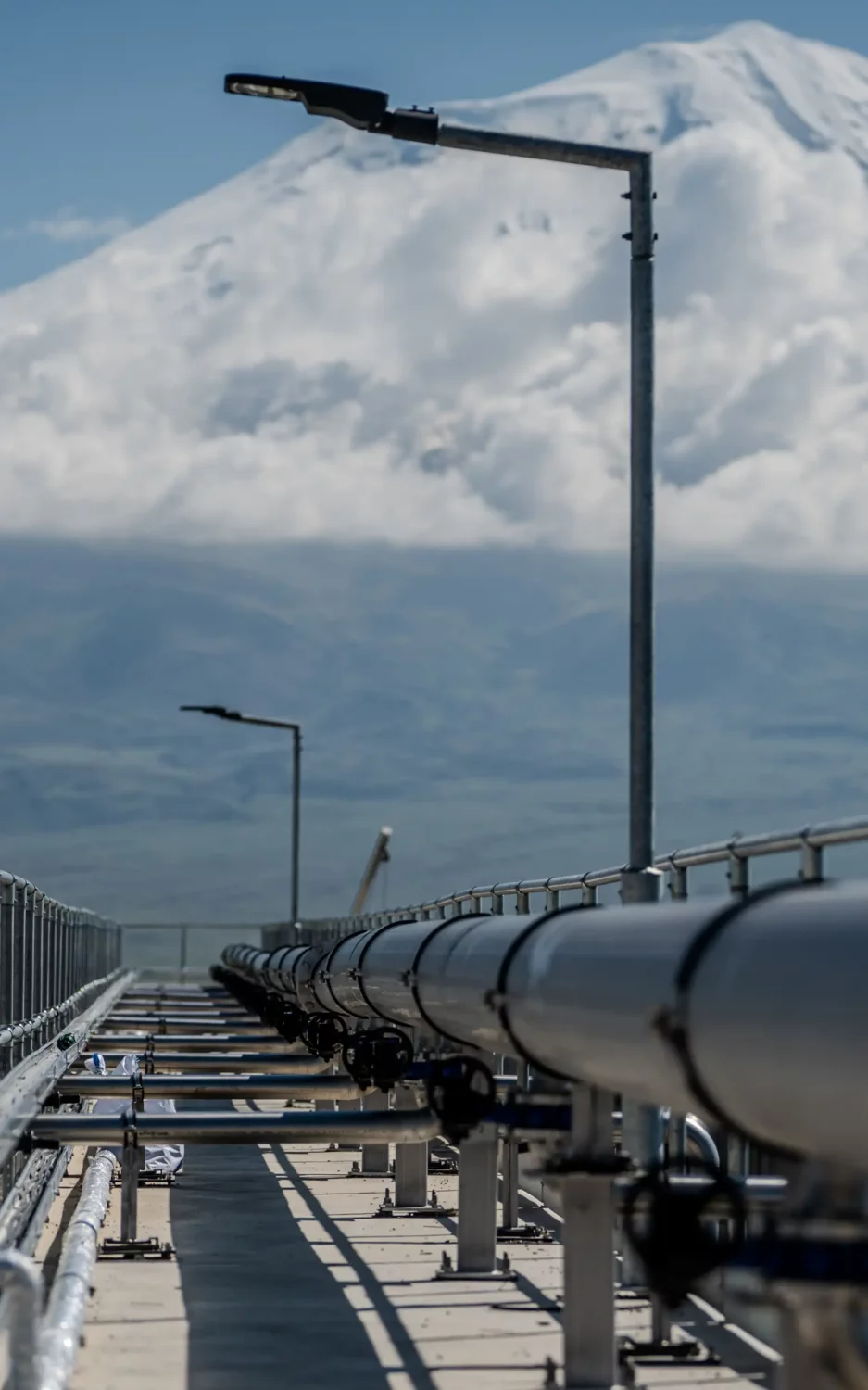 Pipeline walkway at a wastewater treatment facility in Doğubayazıt, with snow-capped Mount Ararat, in the background